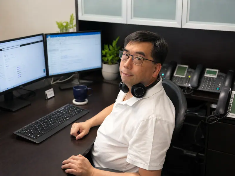 VoIP specialist at a desk with IP phones
